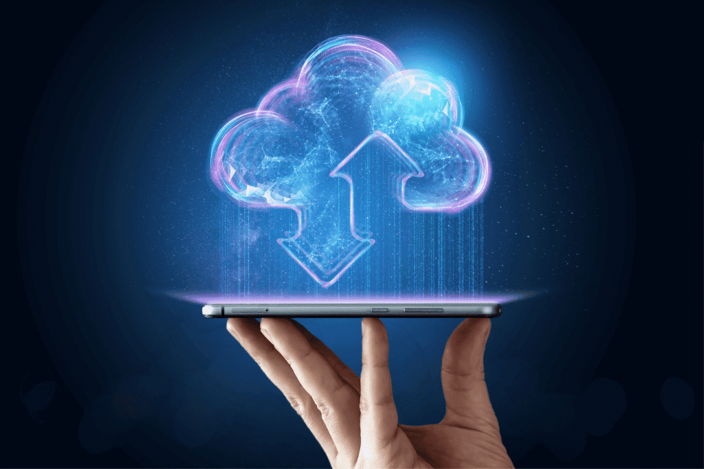 Hand holding a smartphone with a glowing cloud upload/download icon hovering above it.